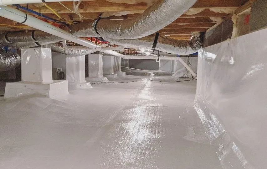 Bright white encapsulated crawl space with wrapped support piers and sealed liner
