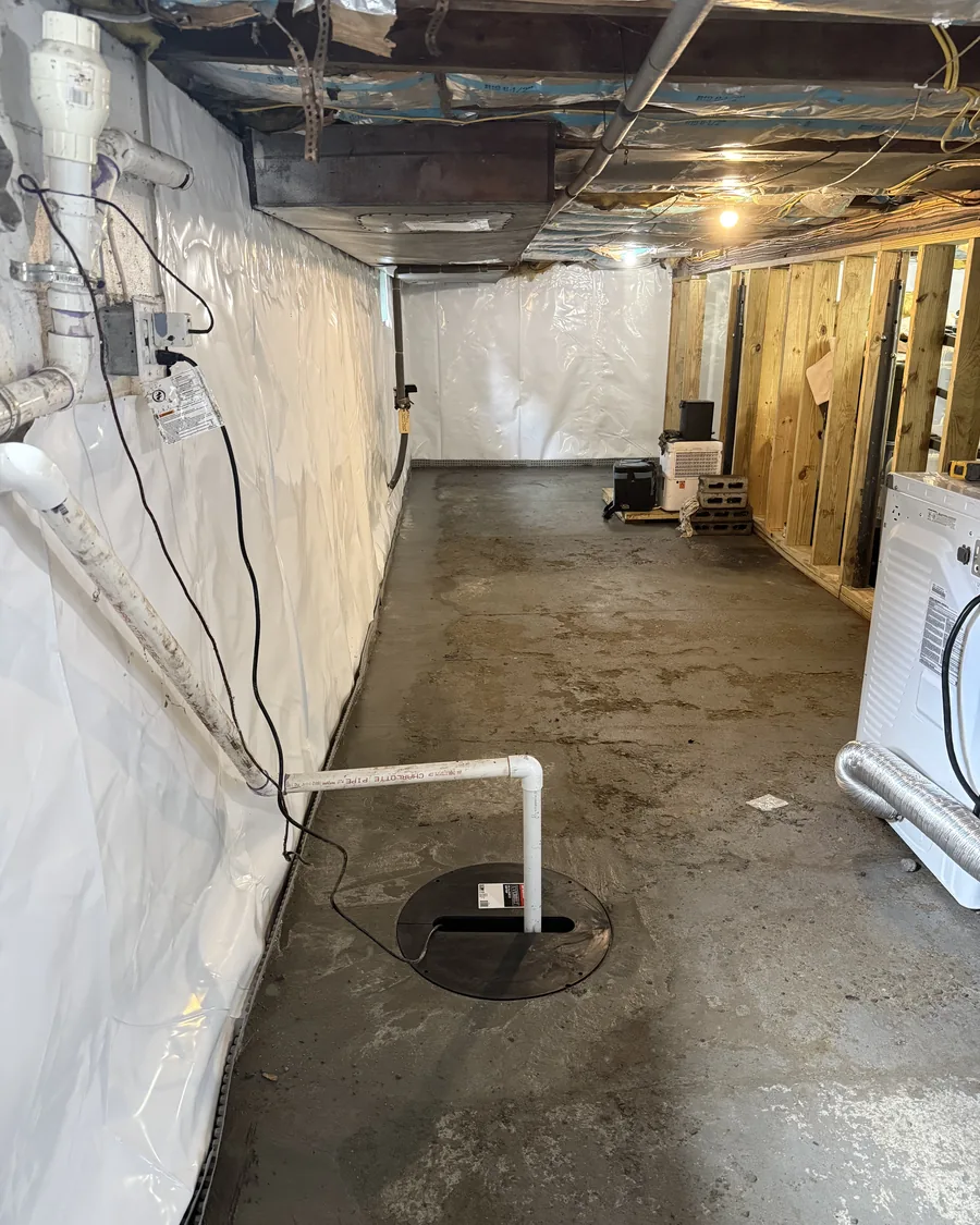 Sealed sump basin lid with the discharge line rising from the pump